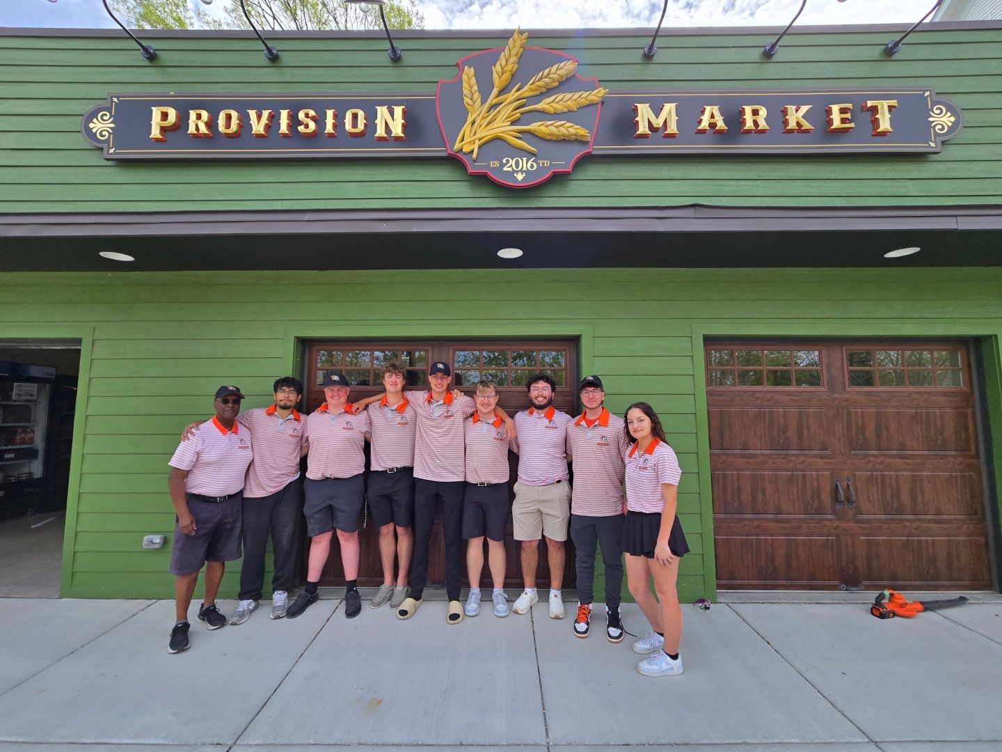 GovState Head Men's-Women's Golf Coach Fred Hawkins (L) pictured with the men's and women's golf team, community service project at the Monee Provision Market earlier this month, May, 2025.