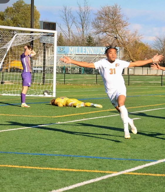 (31) Horace Spence celebrating scoring his game-winning goal to beat Olivet Nazarene University 2-1 in the CCAC Semifinals.