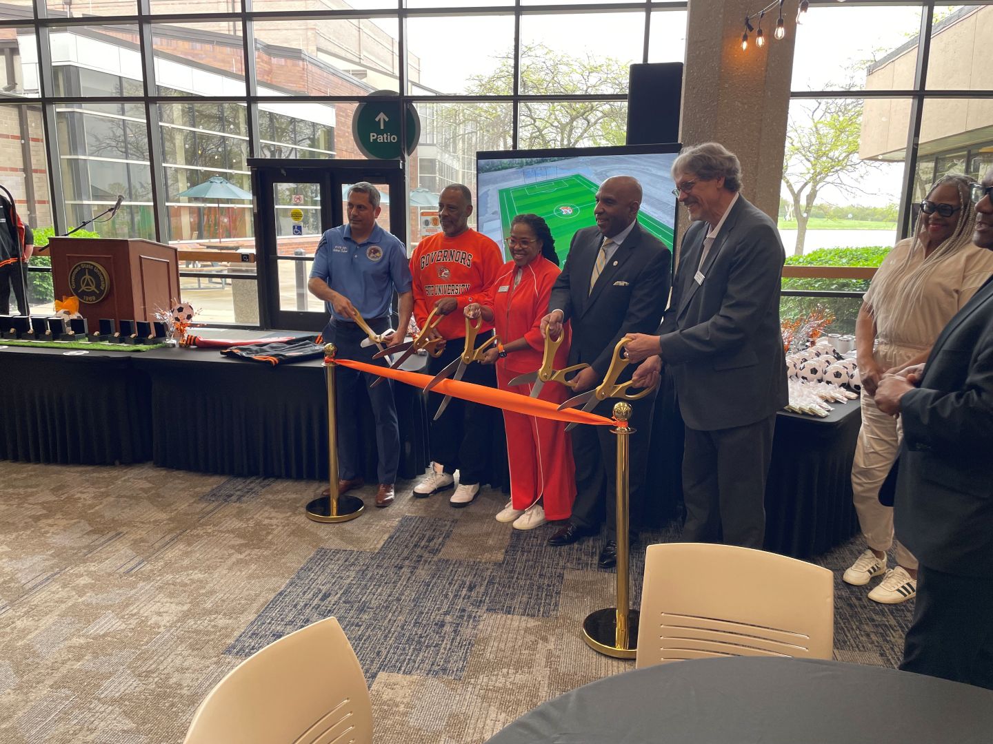 GovState President Dr. Ester leads a group cutting the ribbon to open the new men's and women's soccer complex on campus Friday, April 24. The Jaguars will play and practice at the new 3.2 million dollar state of the art turf field complex on campus for the 2026 Fall season.